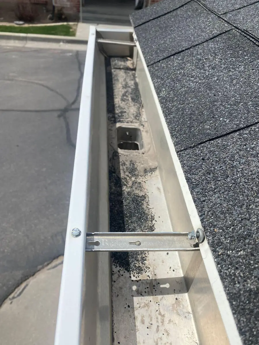 Clean white gutter with hidden hangers after a clean-out